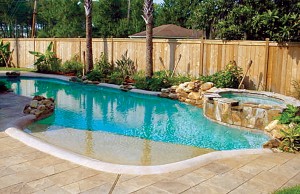 free form pool with rock features and elevated spa with spillovers