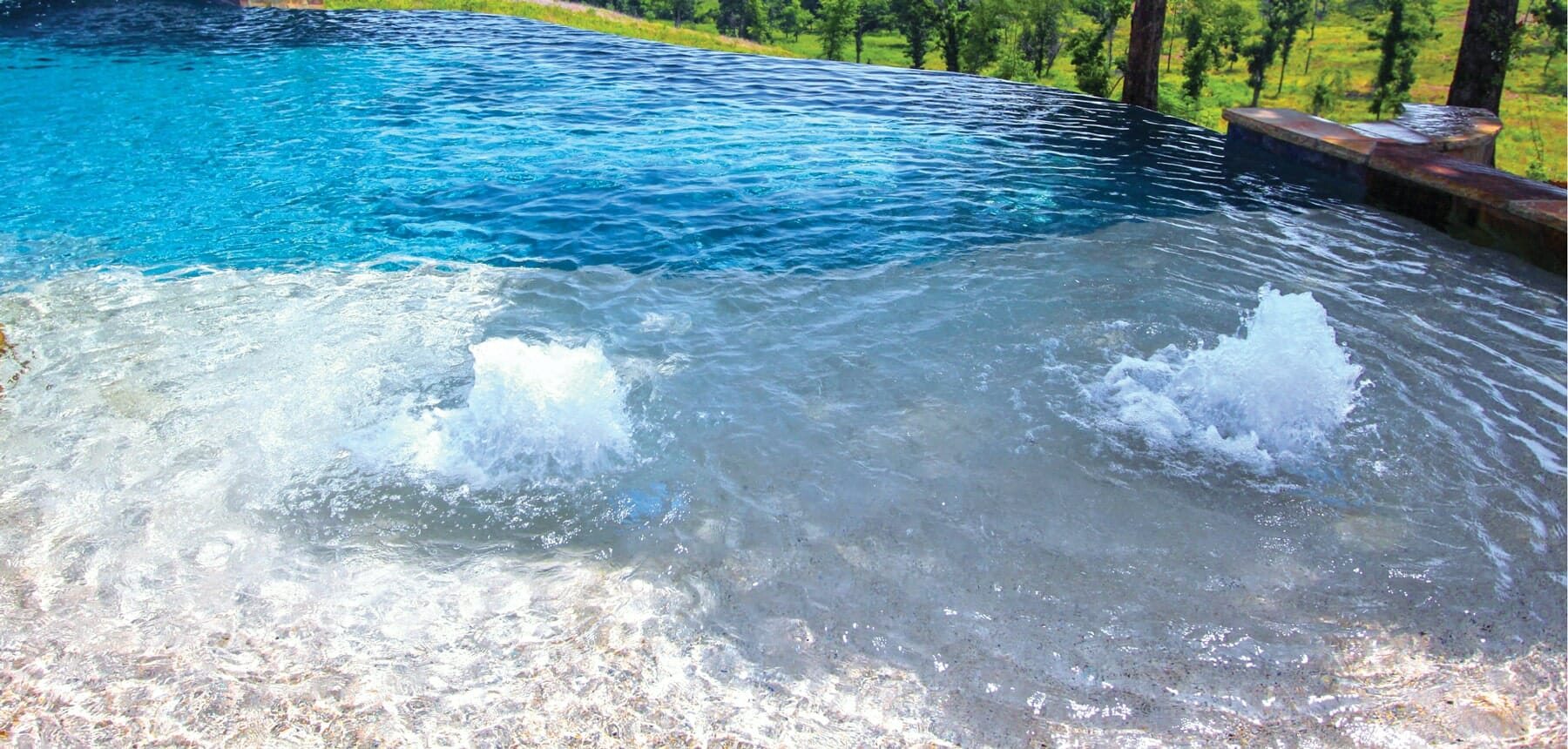 bubbler water fountain on infinity edge pool