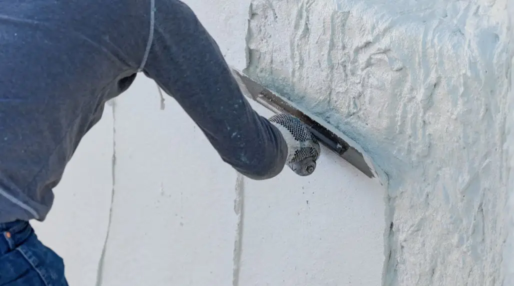 Applying a color quartz pool finish to improve surface durability and protect the pool interior.