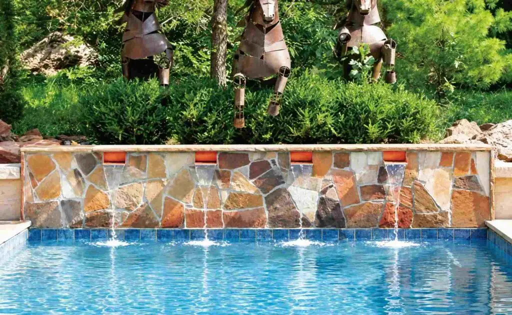 Droplet-style cascade waterfalls falling like rain from an Arizona flagstone pool wall