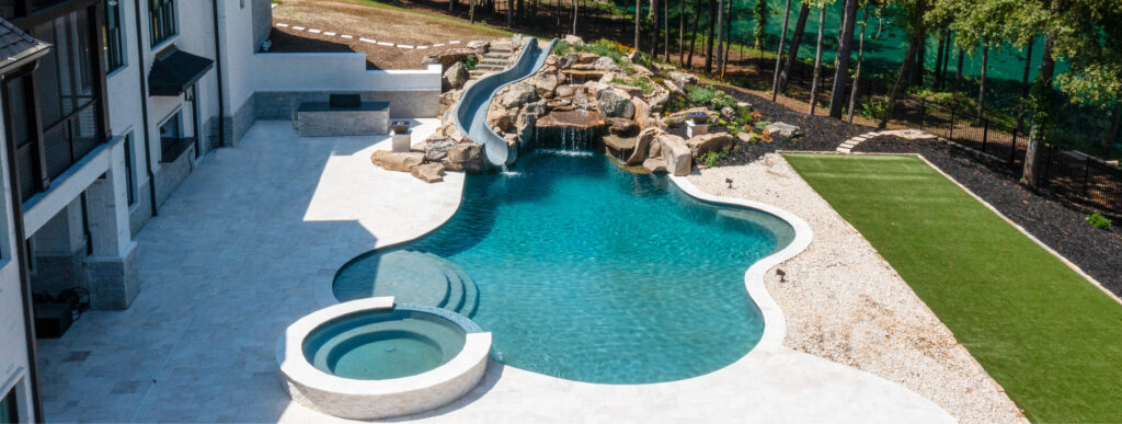Custom pool in Atlanta with rock waterfall and integrated slide.
