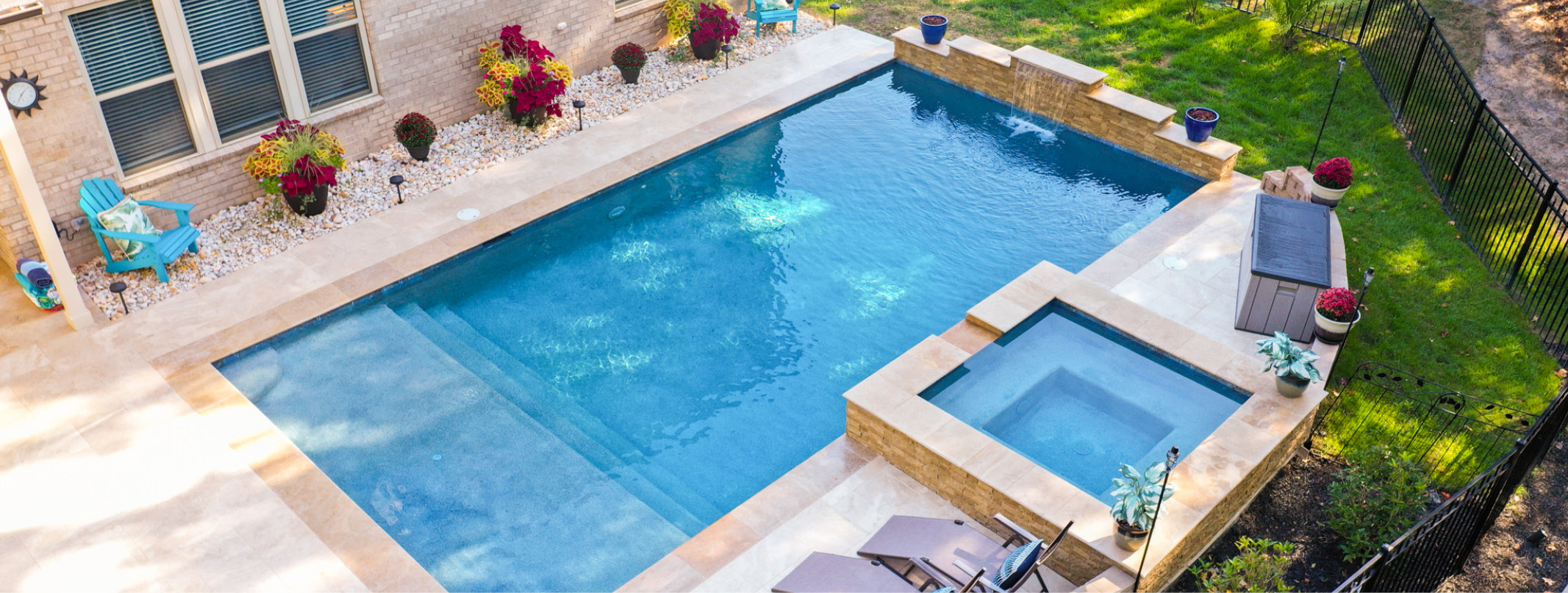 Gunite pool with large tanning ledge entry steps and elevated square spa.