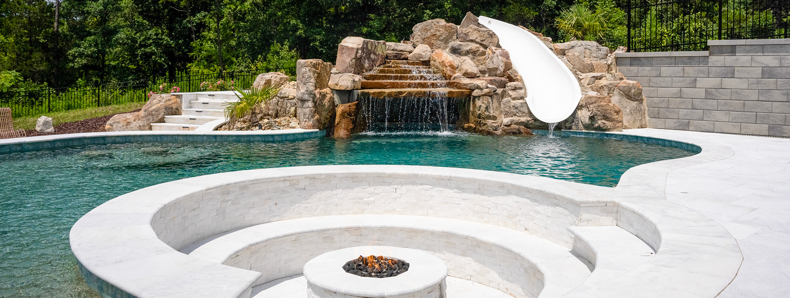 Conversation pit that's integrated into custom Raleigh swimming pool.