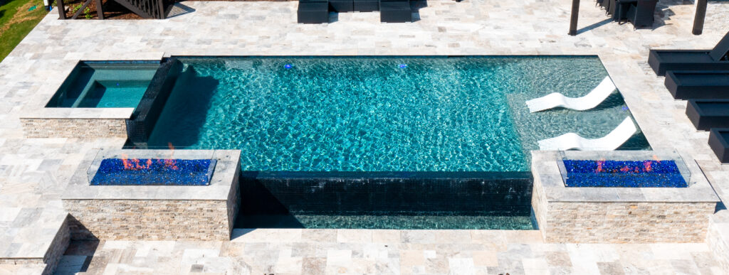Infinity swimming pool with two fire pits in Raleigh.