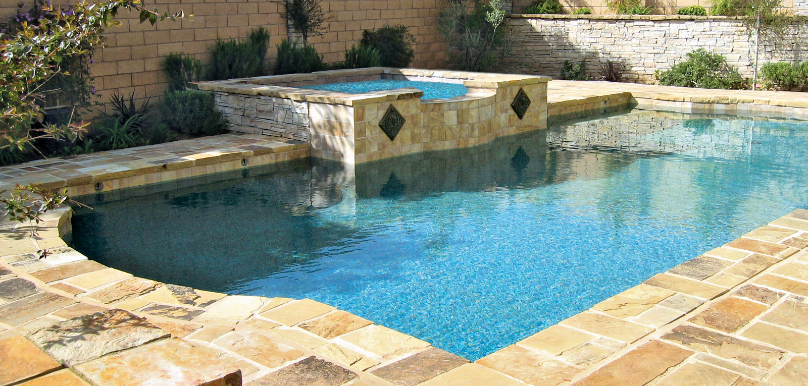 Backyard Roman pool with square spa.