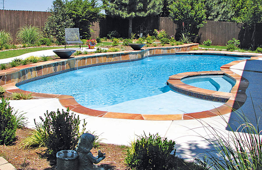 Custom shaped spa built into gunite swimming pool