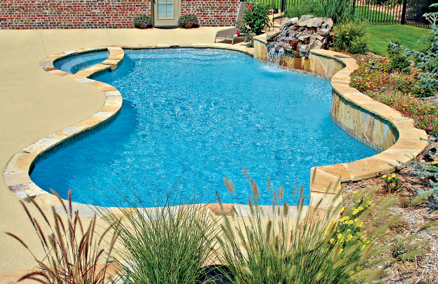 Interior freeform gunite spa attached to custom pool