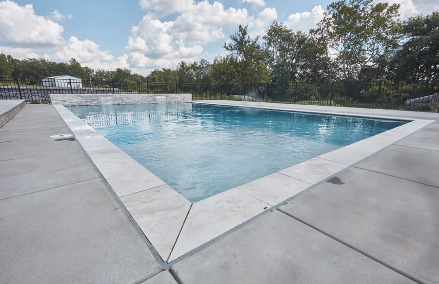 Modern geometric swimming pool with sleek coping