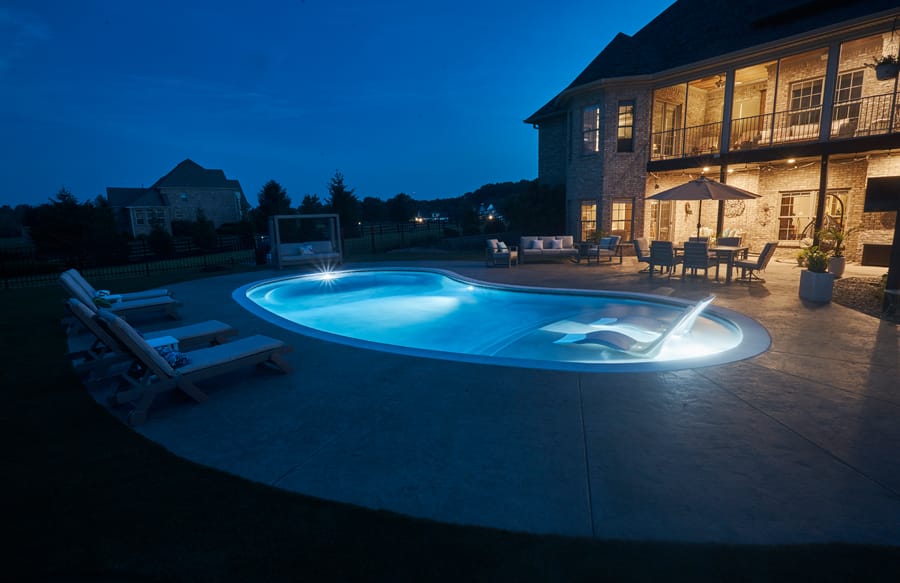 Custom swimming pool illuminated at night