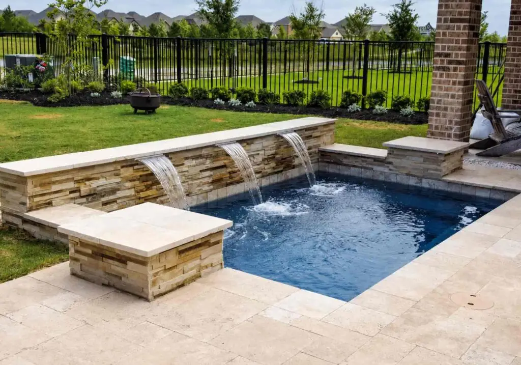 Small dark-water plunge pool with three cascade waterfalls and a travertine deck