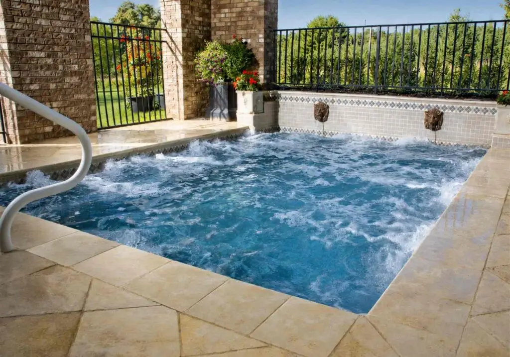 Square spool with hydrotherapy jets running and a stone deck