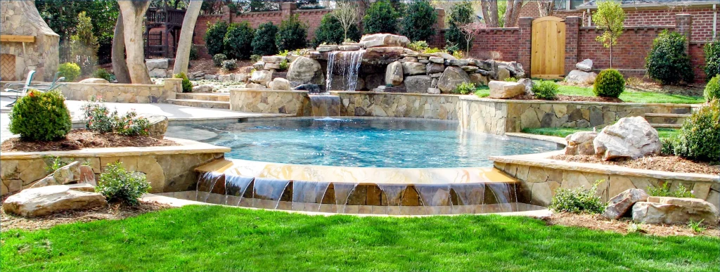 Infinity pool with rock waterfall in Nashville backyard.