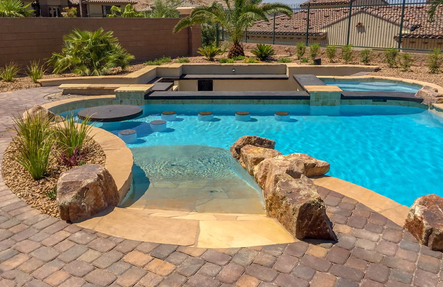 Beach-entry swimming pool with swim-up bar.