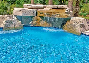 Freeform pool with natural rock waterfall in Temecula backyard