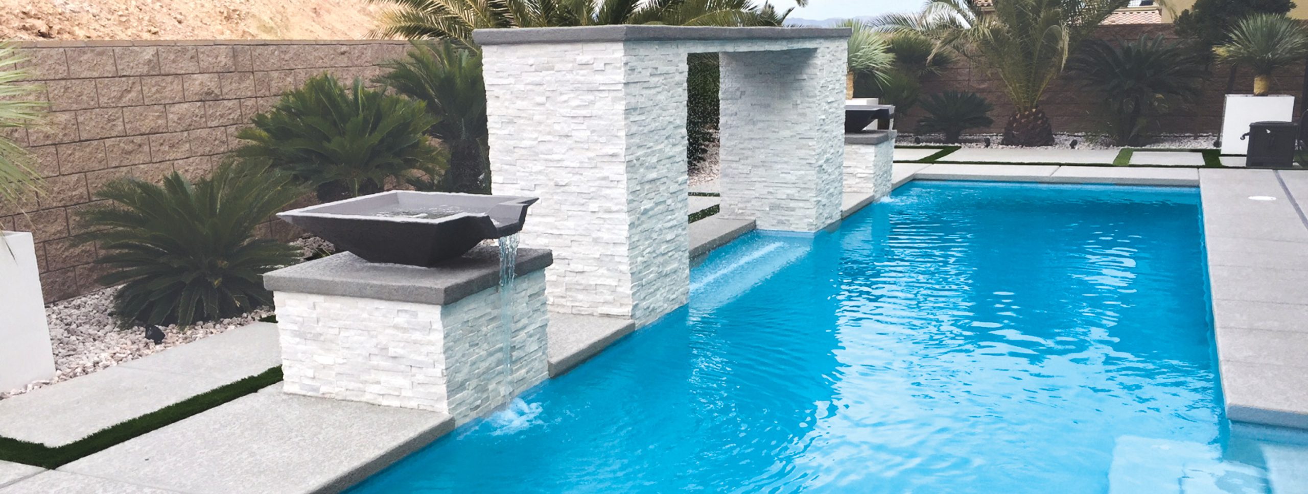 Custom swimming pool with modern backyard features in Tucson