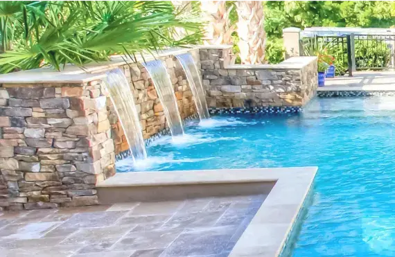 Custom residential pool with stylish water features