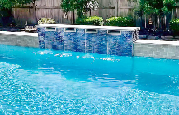 Pool renovation featuring cascading waterfall design in Houston