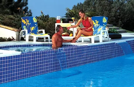 Family enjoying a relaxing backyard poolside staycation experience