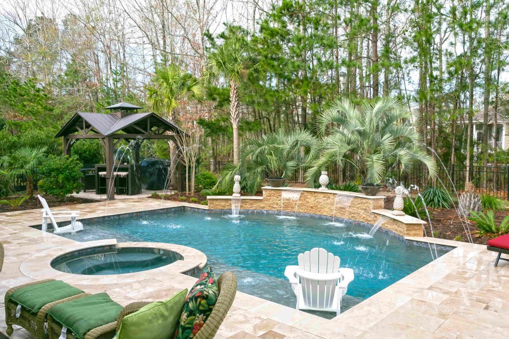 Aerial view of a freeform gunite pool with integrated spa and tanning ledge