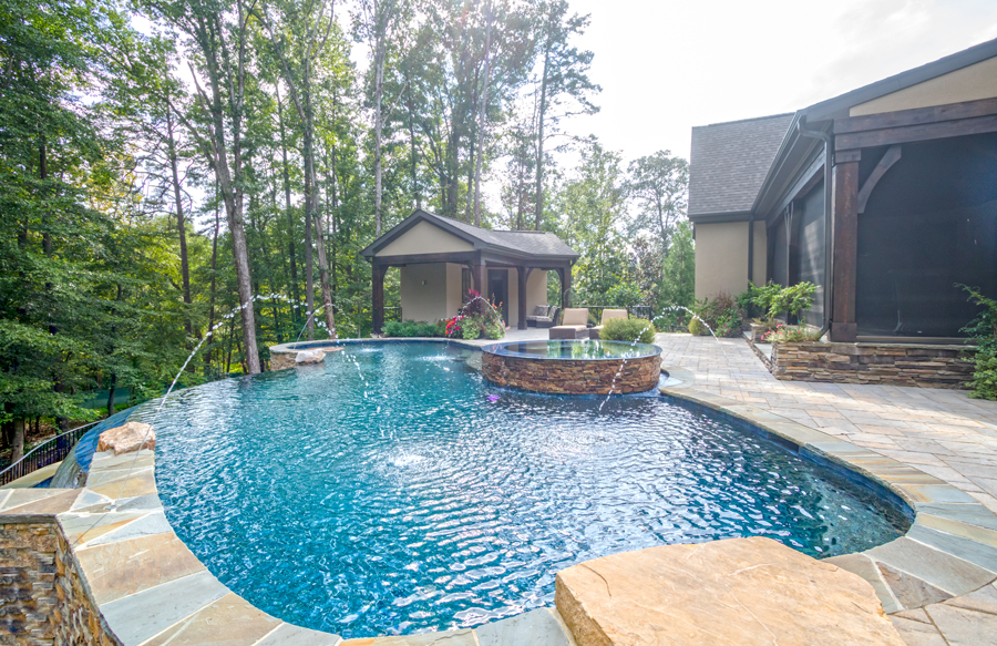 Inground swimming pool finished with durable pebble interior surface