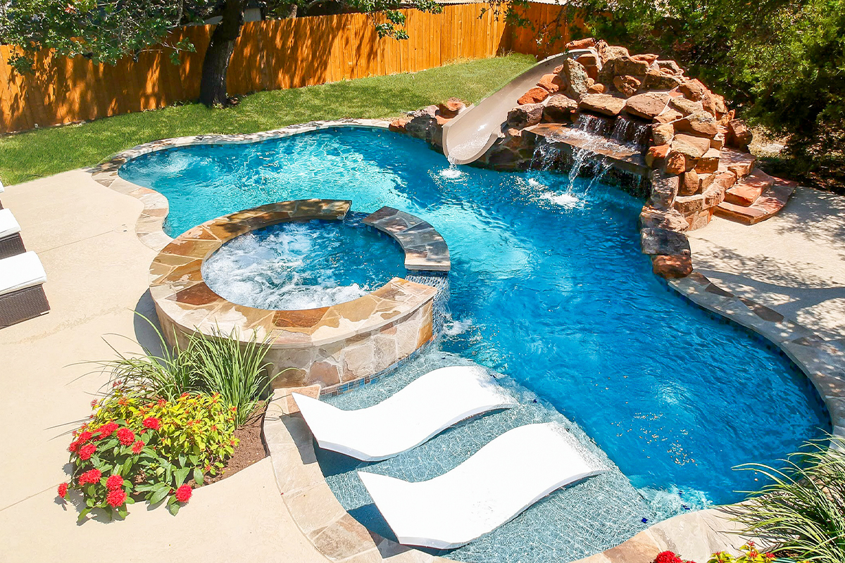Natural lagoon-style swimming pool with tropical landscaping