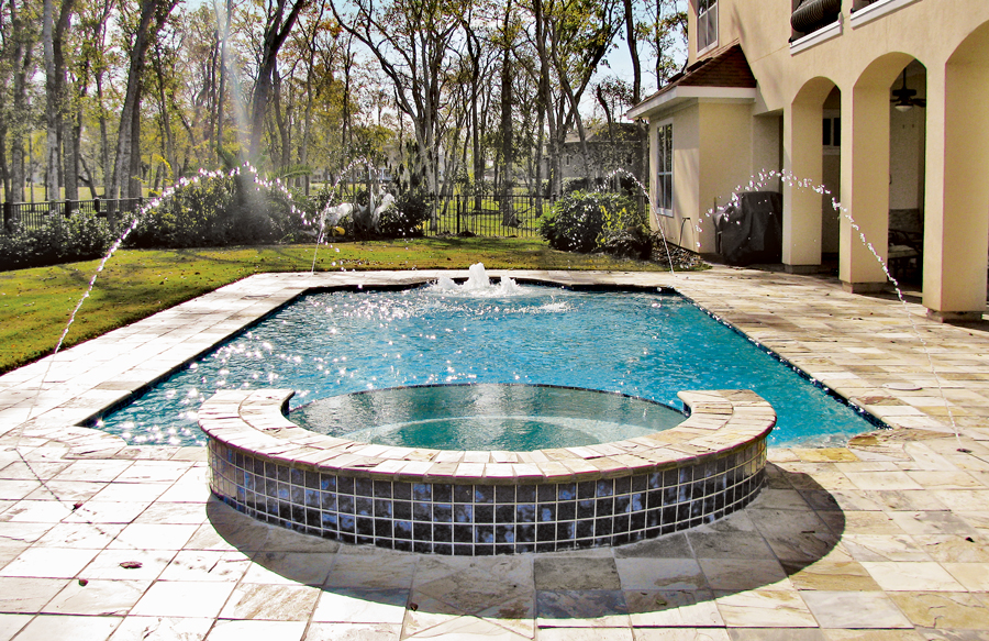 Custom pool and spa featuring elegant waterfalls and water accents