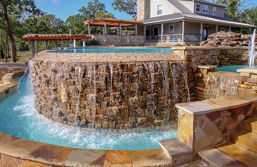 pool-water-flowing-over-stone-infinity-wall-into-catch-basin